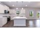 A bright kitchen features white cabinets, an island, and stainless steel appliances at 279 Hopewell Branch Ct, Smithfield, NC 27577