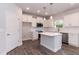 This well-lit kitchen features white cabinets, island, and stainless appliances at 279 Hopewell Branch Ct, Smithfield, NC 27577