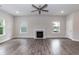 Spacious living room with hardwood floors, ceiling fan, and a fireplace at 279 Hopewell Branch Ct, Smithfield, NC 27577