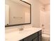 Bright bathroom featuring a black framed mirror, black vanity with a white countertop and a white tub/shower combo at 3002 Dog Rose Dr # 310, Durham, NC 27703