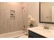 Neutral bathroom features a tiled shower with a built-in niche and black framed mirror above the vanity at 3002 Dog Rose Dr # 310, Durham, NC 27703