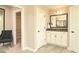 Bathroom with a framed mirror, grey vanity, and open entry to a walk-in closet at 3002 Dog Rose Dr # 310, Durham, NC 27703
