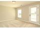 Neutral bedroom featuring soft carpet, a window and a door to the outside for lots of natural light at 3002 Dog Rose Dr # 310, Durham, NC 27703