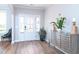 Inviting foyer with hardwood floors, plenty of natural light, stylish console table, and an ornate decorative plant at 3002 Dog Rose Dr # 310, Durham, NC 27703