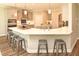 Modern kitchen with a quartz countertop island, stainless steel appliances, and gray cabinets at 3002 Dog Rose Dr # 310, Durham, NC 27703