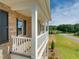 Charming brick home with a covered porch, white railings, and scenic views at 3002 Dog Rose Dr # 310, Durham, NC 27703