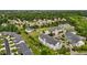 Aerial view of a building surrounded by trees with a parking lot and green grass at 3015 Winston Dr # 117, Burlington, NC 27215