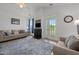Bright living room featuring a fireplace, high ceiling, light colored sofa, and french doors at 3015 Winston Dr # 117, Burlington, NC 27215