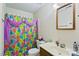 Bathroom with a vibrant shower curtain, classic fixtures, and a vanity sink at 305 Reynolds N Ave, Durham, NC 27707