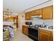 Traditional kitchen with tiled floor, wooden cabinetry, and classic appliances at 305 Reynolds N Ave, Durham, NC 27707