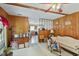 Living room with wood paneling, a ceiling fan, and an open layout flowing into the kitchen at 305 Reynolds N Ave, Durham, NC 27707