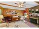 Cozy living room showcases wood paneling, a brick fireplace, a ceiling fan, and classic decor at 305 Reynolds N Ave, Durham, NC 27707