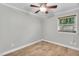 An empty bedroom with wood tile flooring, a ceiling fan, and a window at 308 Lynn Road, Durham, NC 27703