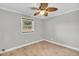 An empty bedroom with a ceiling fan and a window with natural light at 308 Lynn Road, Durham, NC 27703