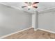 Empty bedroom with wood tile flooring, neutral walls, ceiling fan and a closet at 308 Lynn Road, Durham, NC 27703