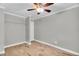 An empty bedroom with wood tile flooring, a ceiling fan, and a closet at 308 Lynn Road, Durham, NC 27703