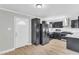 Well-appointed kitchen with stainless steel appliances, modern cabinetry, and stylish tile floors at 308 Lynn Road, Durham, NC 27703