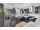 Updated kitchen with stainless steel appliances, marble countertops, and modern fixtures at 308 Lynn Road, Durham, NC 27703