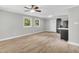 Bright living room featuring hardwood floors, ceiling fan, and access to a modern kitchen at 308 Lynn Road, Durham, NC 27703