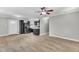 Open-concept living area with sleek black kitchen appliances and stylish tile flooring at 308 Lynn Road, Durham, NC 27703