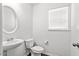 Clean and bright half bathroom featuring a pedestal sink and neutral-toned walls at 3169 Diana Cir, Burlington, NC 27215