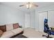 Cozy bedroom featuring a comfortable couch, neutral carpeting, and a modern ceiling fan at 3169 Diana Cir, Burlington, NC 27215