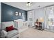 Charming Bedroom featuring a white crib, neutral carpet, and a comfortable gray chair with a red pillow at 3169 Diana Cir, Burlington, NC 27215
