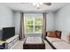 Entertainment space featuring a TV, seating, an ottoman, and plenty of natural light at 3169 Diana Cir, Burlington, NC 27215