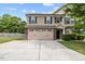 Charming two-story home with a stone accent, tan siding, attached two car garage, and well-kept lawn at 3169 Diana Cir, Burlington, NC 27215
