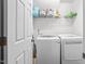 Functional laundry room featuring modern washer and dryer, shelving, and white cabinets at 3169 Diana Cir, Burlington, NC 27215