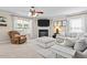 Cozy living room with a fireplace, fan, neutral tones, and lots of natural light at 3169 Diana Cir, Burlington, NC 27215