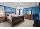 The spacious primary bedroom boasts natural lighting and beautiful dark wood furnishings at 3169 Diana Cir, Burlington, NC 27215