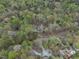 Bird's-eye view of a home surrounded by a dense forest, offering privacy and a natural setting at 3418 Carriage Trl, Hillsborough, NC 27278