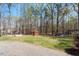Spacious backyard featuring mature trees, storage shed and a play area at 3418 Carriage Trl, Hillsborough, NC 27278