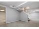 Large basement living area with grey walls, carpet and stairs to the upper level at 3418 Carriage Trl, Hillsborough, NC 27278