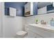 Bathroom with a white vanity, white beadboard and blue wall color at 3418 Carriage Trl, Hillsborough, NC 27278