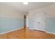 Bedroom with two-tone paint, hardwood floors, and closet with folding doors at 3418 Carriage Trl, Hillsborough, NC 27278