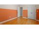 Bedroom with two-tone paint, hardwood floors, doorway, and closet with folding doors at 3418 Carriage Trl, Hillsborough, NC 27278
