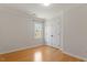 Bedroom with neutral walls, hardwood floors, window, and closet with folding doors at 3418 Carriage Trl, Hillsborough, NC 27278