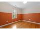 Bedroom featuring two-tone paint and hardwood floors at 3418 Carriage Trl, Hillsborough, NC 27278