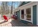 Deck area features outdoor seating and access to the home's interior at 3418 Carriage Trl, Hillsborough, NC 27278