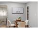 Dining area with modern glass table, seating for four, neutral decor, and bright, airy atmosphere at 3418 Carriage Trl, Hillsborough, NC 27278