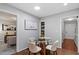 Cozy dining area featuring a modern round table, white chairs, and neutral decor at 3418 Carriage Trl, Hillsborough, NC 27278