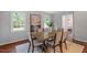 Bright dining area featuring a large wooden table, seating for eight and neutral color palette at 3418 Carriage Trl, Hillsborough, NC 27278