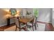 Inviting dining room with seating for eight, stylish decor, and ample natural light at 3418 Carriage Trl, Hillsborough, NC 27278