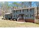Charming two-story home featuring a brick foundation, a front-facing brick stair, and a well-maintained lawn at 3418 Carriage Trl, Hillsborough, NC 27278