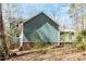 View of home's exterior with partial brick foundation at 3418 Carriage Trl, Hillsborough, NC 27278