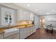 Bright kitchen featuring white cabinetry, granite countertops, and a stainless steel sink at 3418 Carriage Trl, Hillsborough, NC 27278