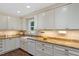 Beautiful kitchen featuring white cabinetry, granite countertops, and modern appliances at 3418 Carriage Trl, Hillsborough, NC 27278