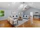Open concept living room boasting hardwood floors, high ceilings, and modern decor at 3418 Carriage Trl, Hillsborough, NC 27278
